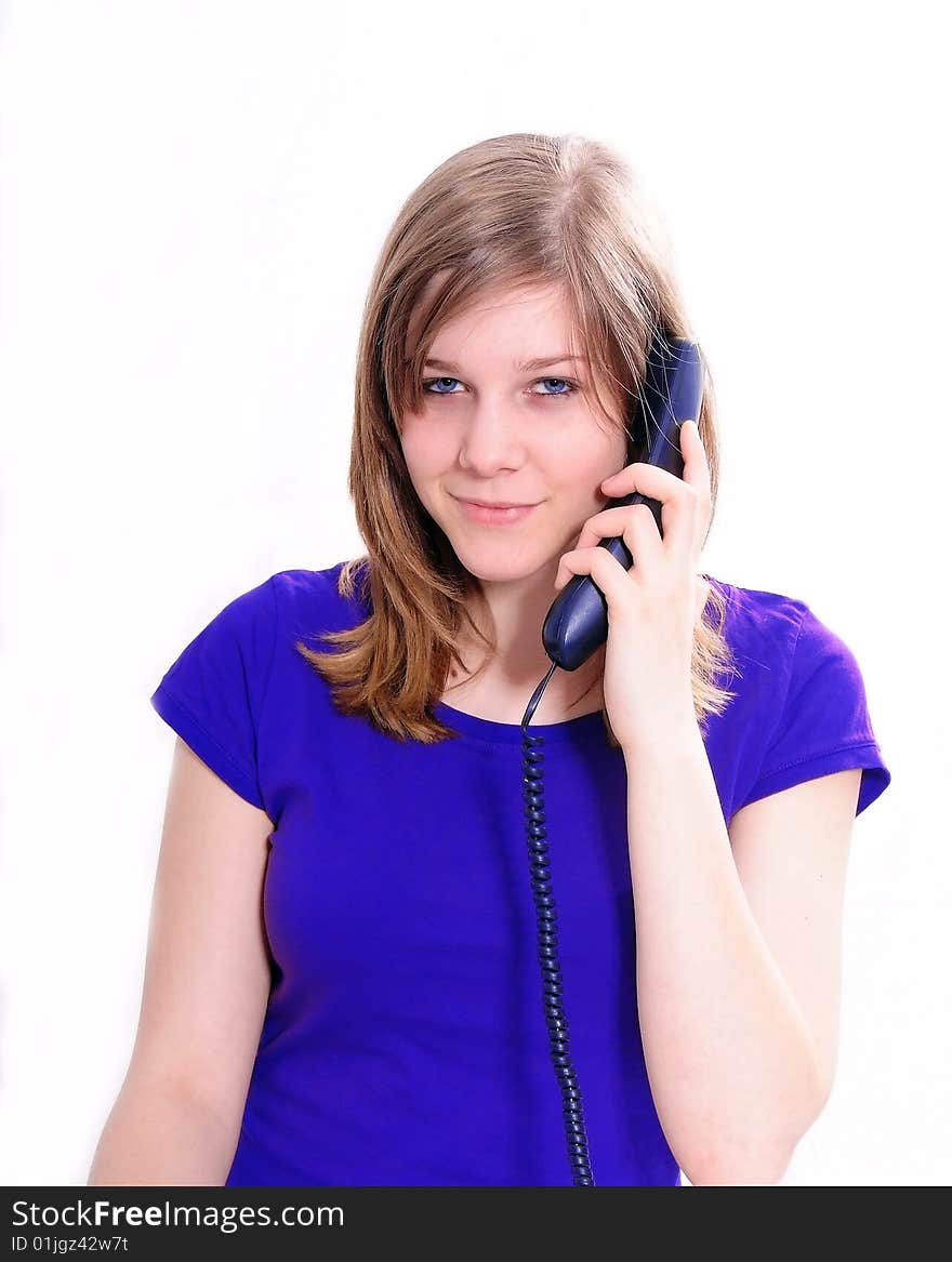 Studio shot of a beautiful brunette woman communicating on the telephone. Studio shot of a beautiful brunette woman communicating on the telephone