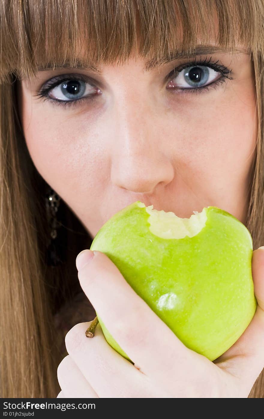 Young blue eyes girl with green apple. Young blue eyes girl with green apple.