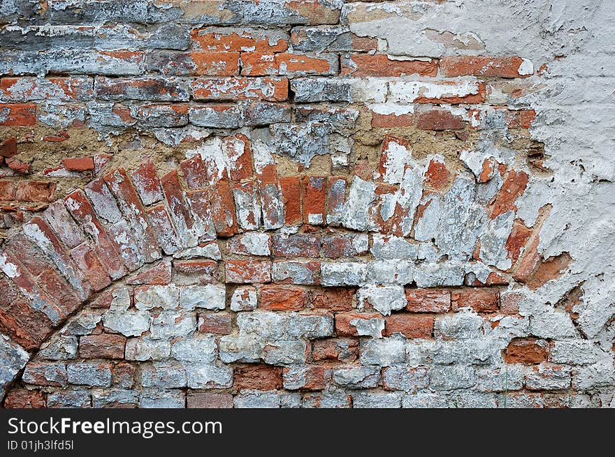 Fragment of tumbledown plastered brick wall. Fragment of tumbledown plastered brick wall