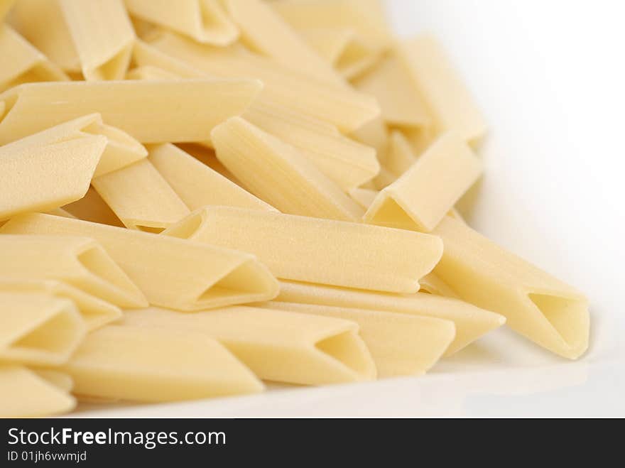 Raw macaroni on the white table. Raw macaroni on the white table