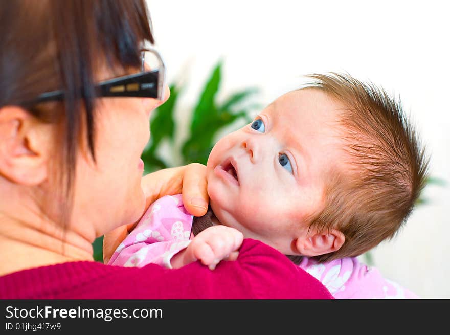 Baby girl and comforting young mother