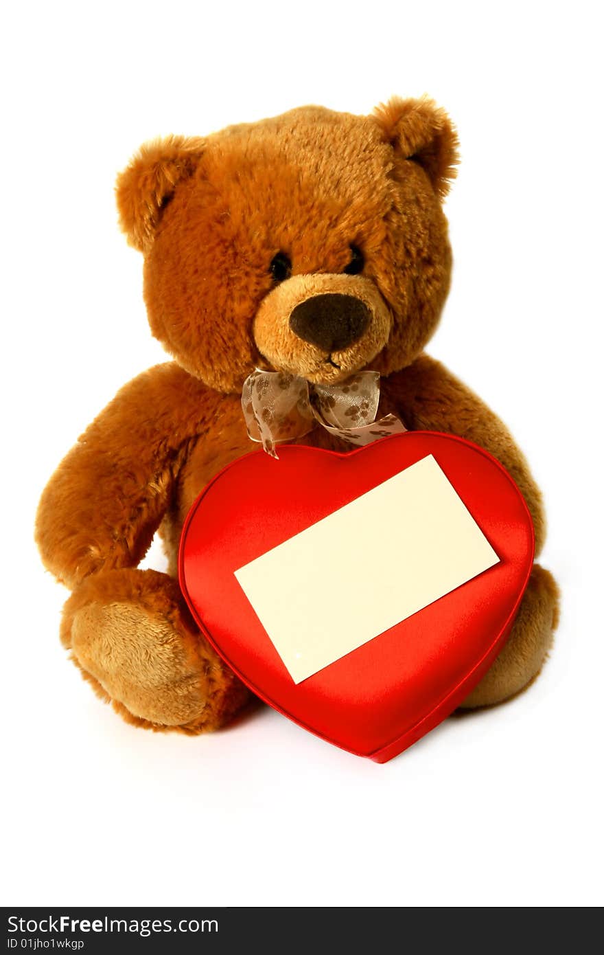 Teddy bear with box of sweets in the shape of heart and a card for the invitation. Teddy bear with box of sweets in the shape of heart and a card for the invitation.