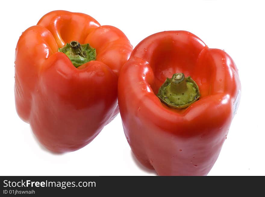 Two red peppers on a white background