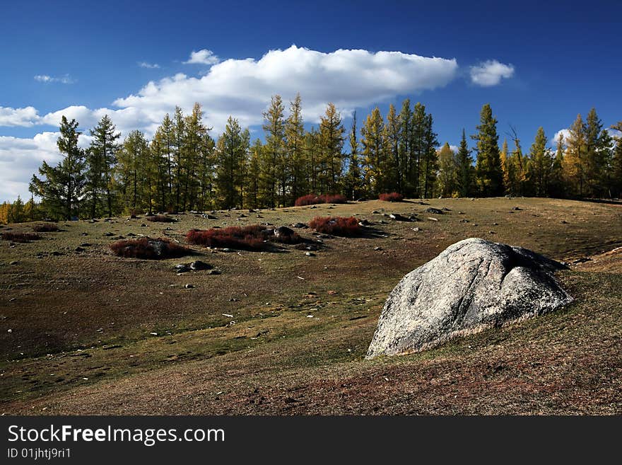 Autumn landscape, blue sky with white clouds and pasture, rock. Autumn landscape, blue sky with white clouds and pasture, rock.