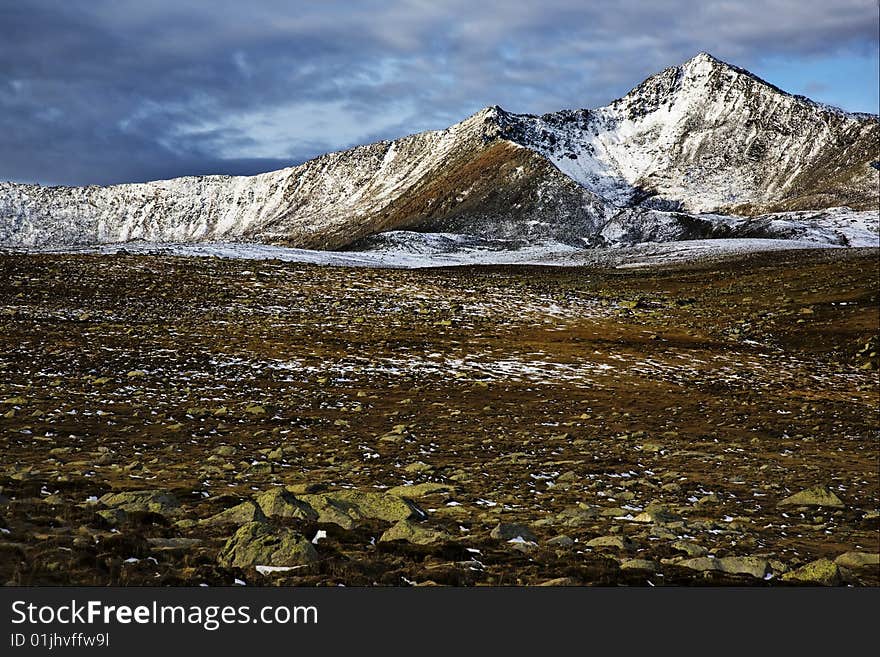 The mountains under the cloudy sky,xinjiang,china. The mountains under the cloudy sky,xinjiang,china