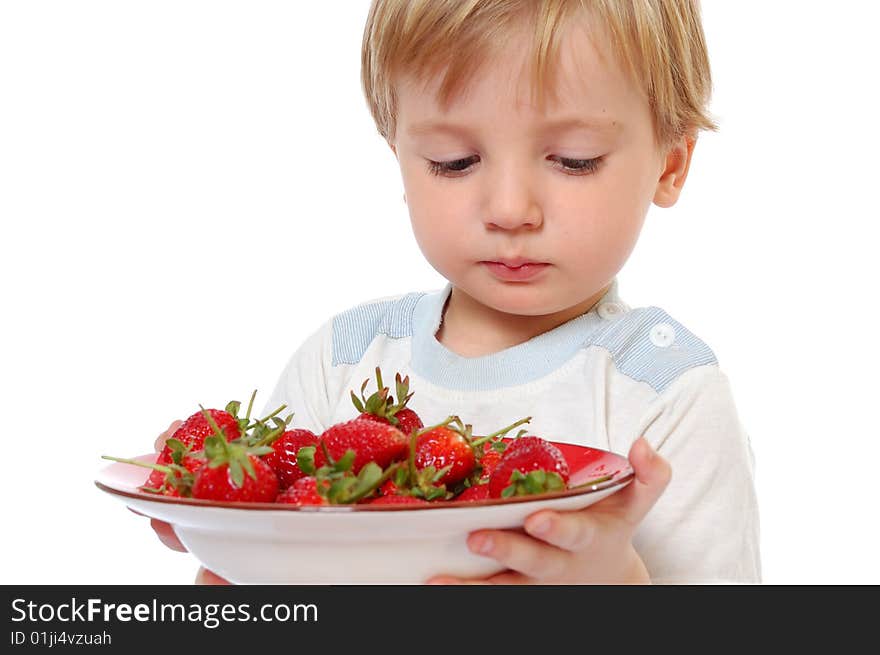 Attractive boy looking at the strawberry. isolated on the white. Attractive boy looking at the strawberry. isolated on the white.