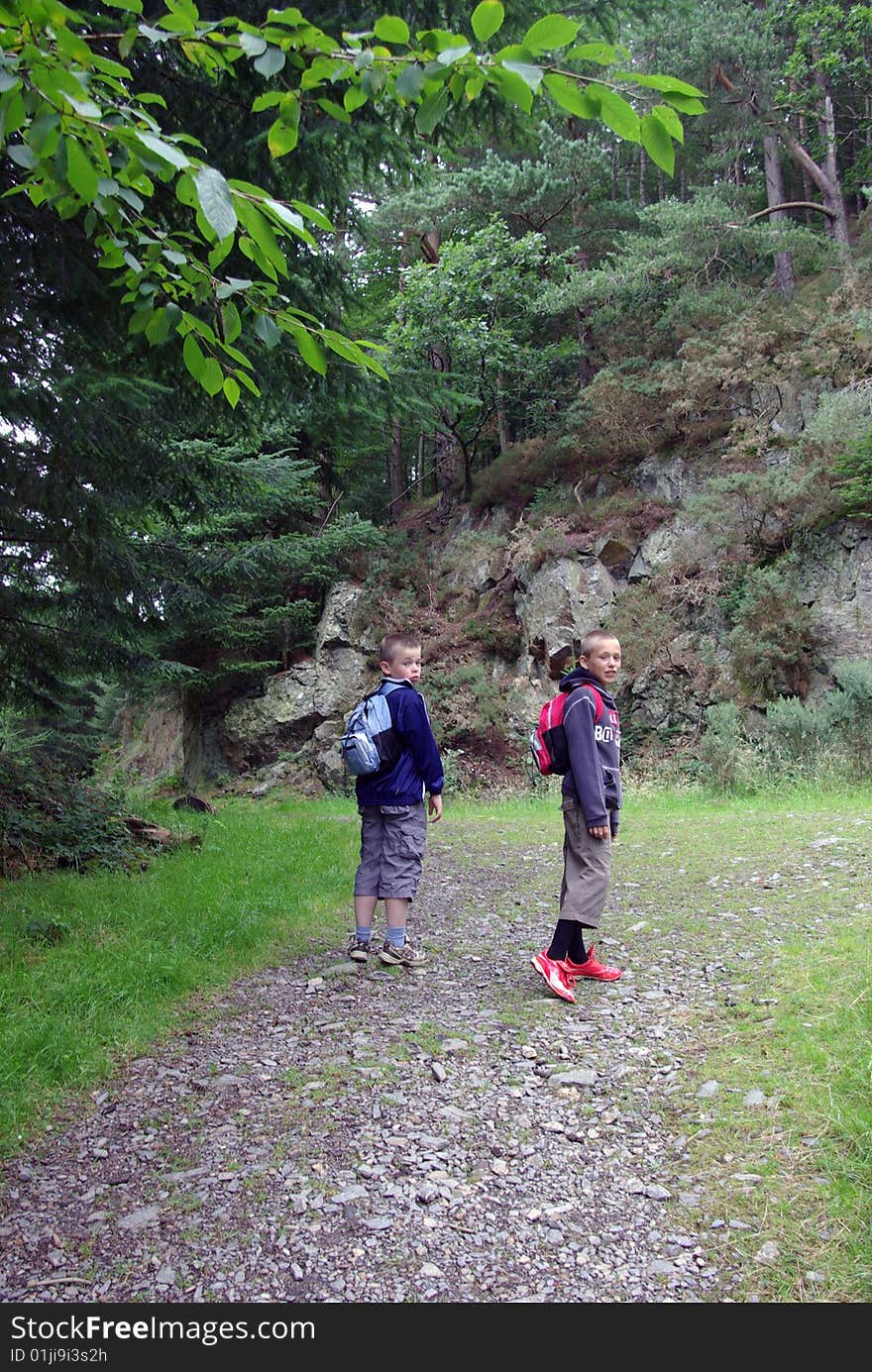 Two boys walking up hillside. Two boys walking up hillside.