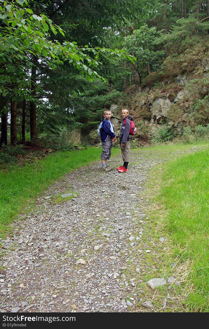 Boys walking up hillside in Lake District. Boys walking up hillside in Lake District.