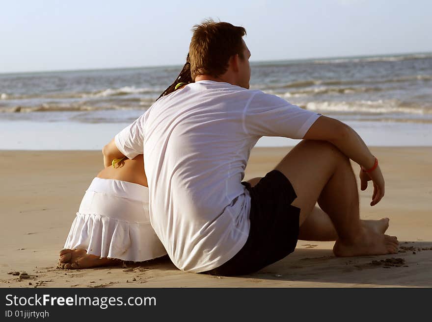 couple at the beach by sunset