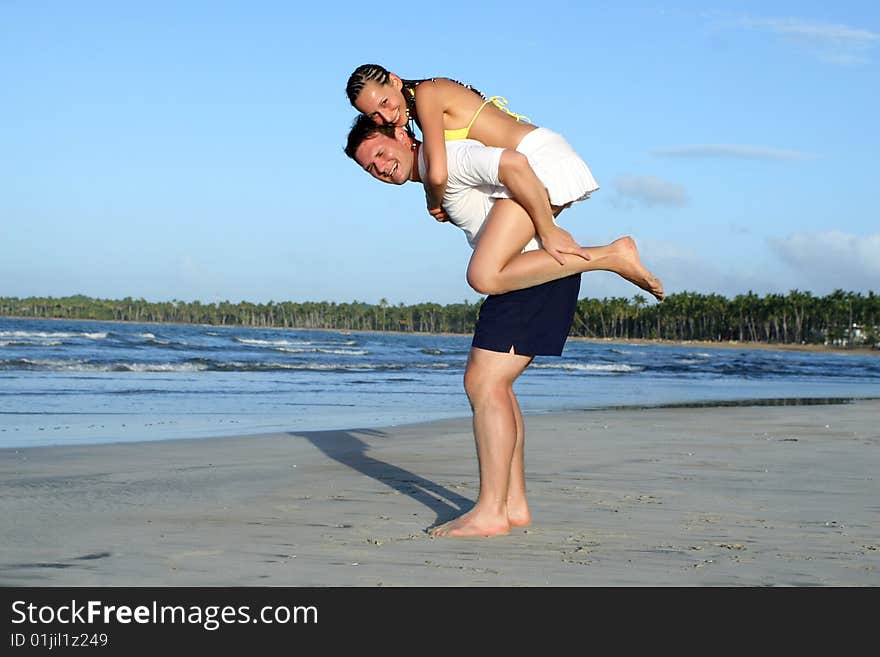 Natural couple at the beach by sunset