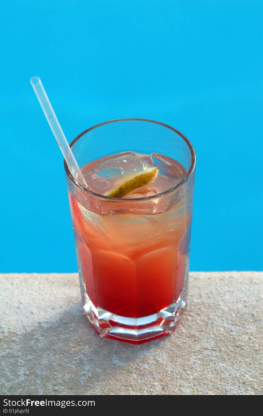 FRUIT COCKTAIL STANDS ON EDGE OF POOL