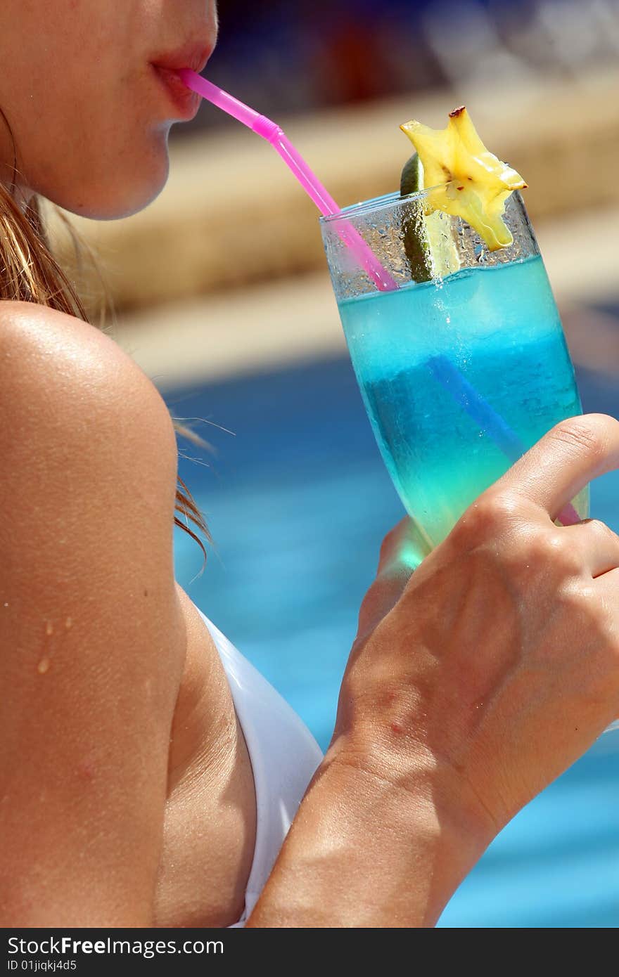 Woman drinking fresh cocktail by the swimming pool. Woman drinking fresh cocktail by the swimming pool