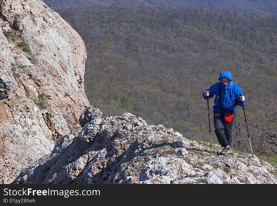 Hiking in mountains with sticks for walking in the cold summer. Hiking in mountains with sticks for walking in the cold summer.