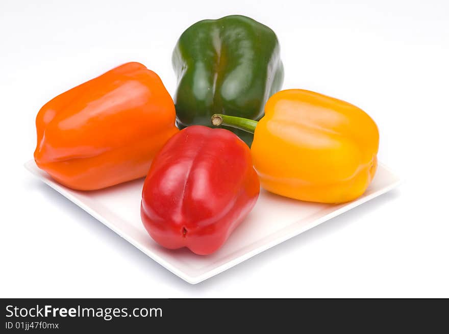 A orange, yellow, red and green fresh paprika. A orange, yellow, red and green fresh paprika