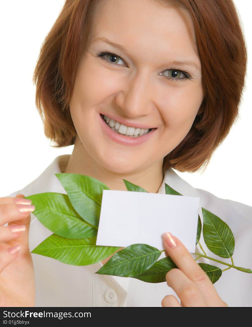 Smiling girl with a business card and leaves of plants. Focusing on the eyes. Smiling girl with a business card and leaves of plants. Focusing on the eyes