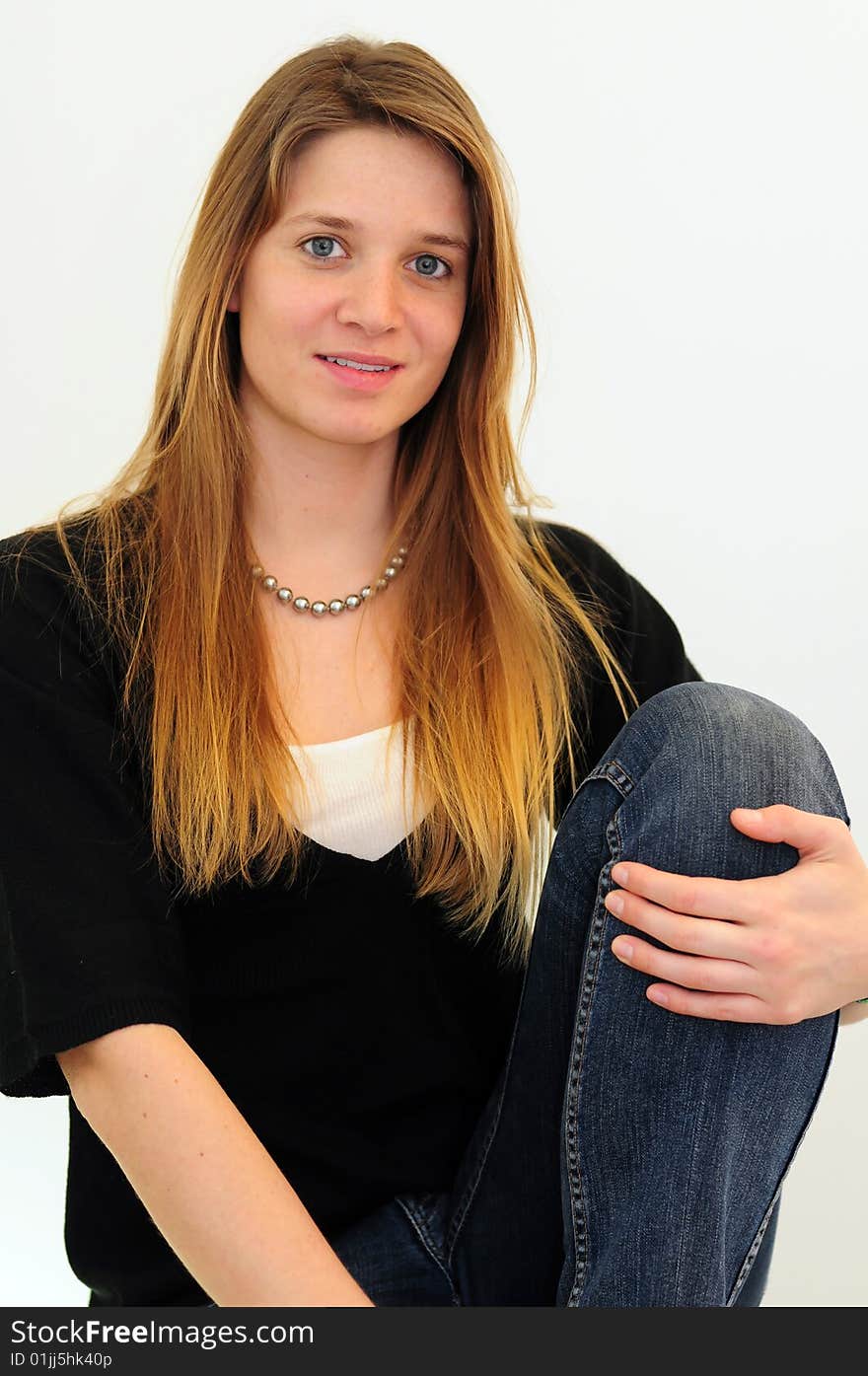 Attractive red head girl on white background in jeans and black shirt. Attractive red head girl on white background in jeans and black shirt