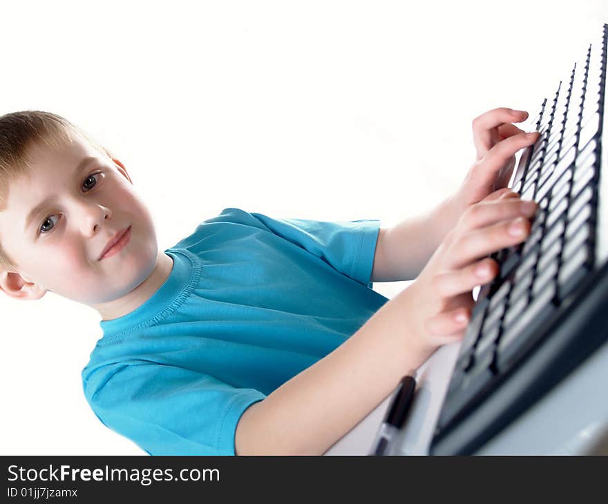 Young boy using a keyboard. Young boy using a keyboard