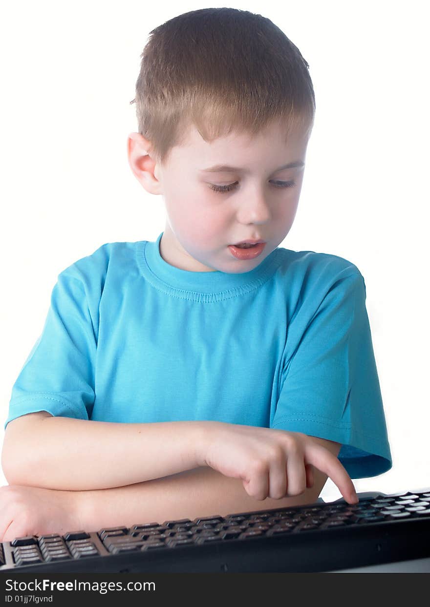 Young boy using a keyboard. Young boy using a keyboard