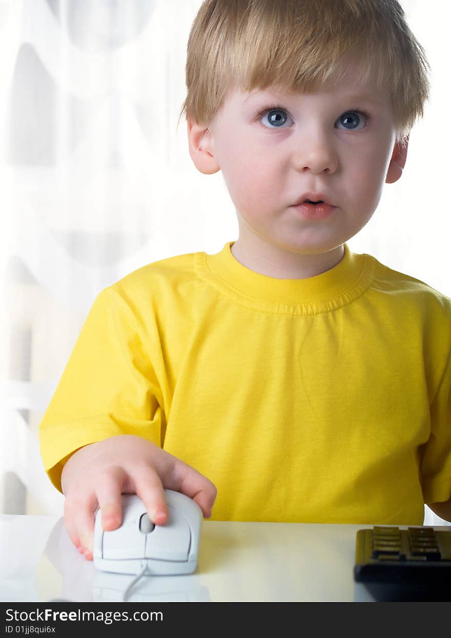 Little boy using a mouse on white background