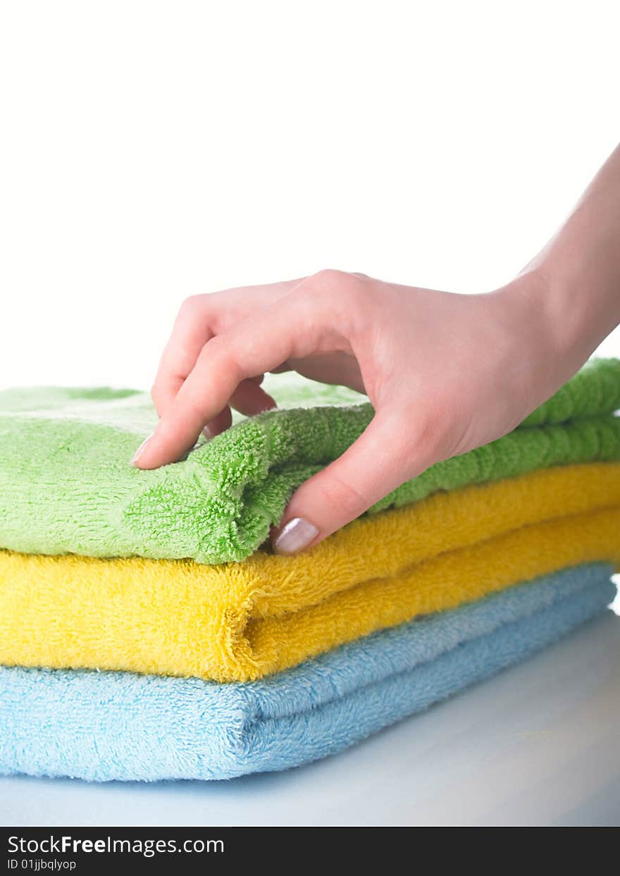 Three terry multi-coloured towels on a table