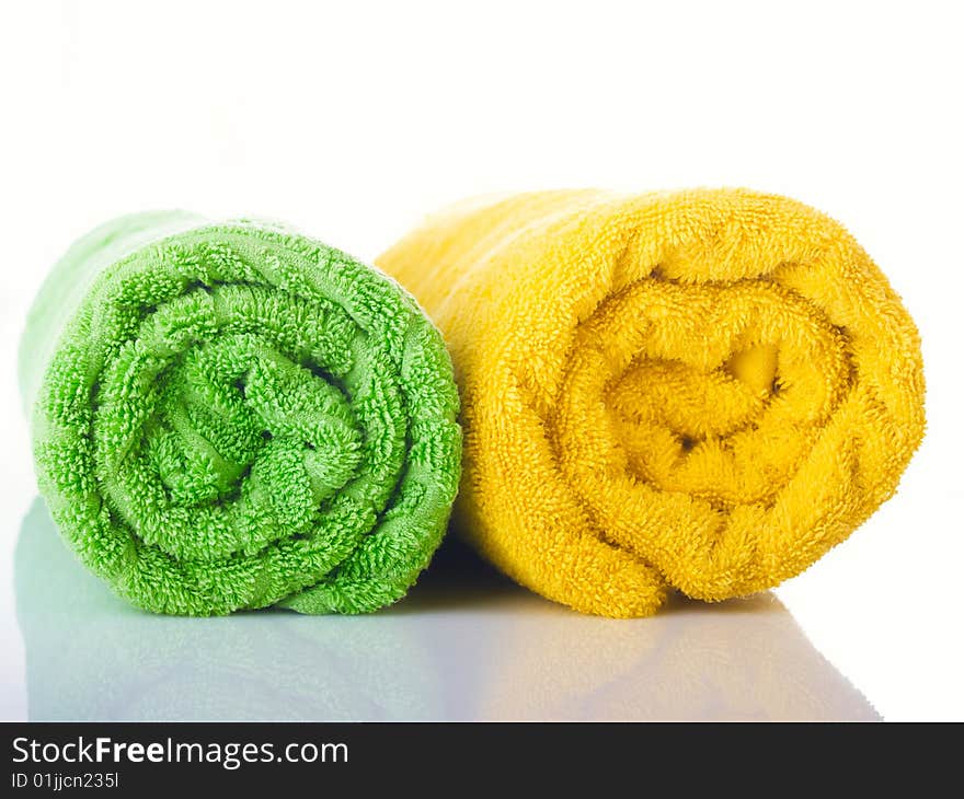 Two terry multi-coloured towels on a table