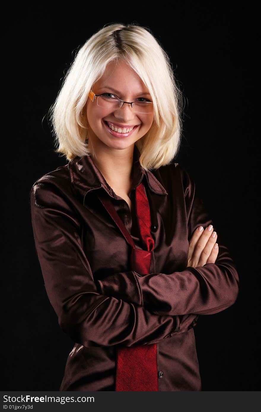 Smiling beautiful lady with necktie and glasses on a black background