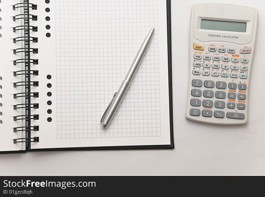 Scientific Calculator Next To Elegant Silver Pen