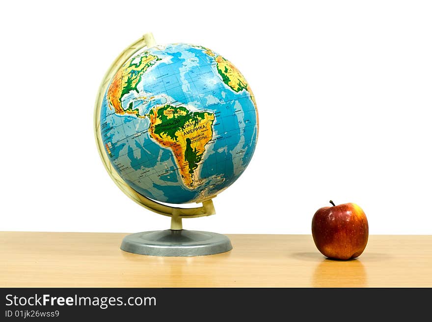 Globe on a table on a white background. Globe on a table on a white background