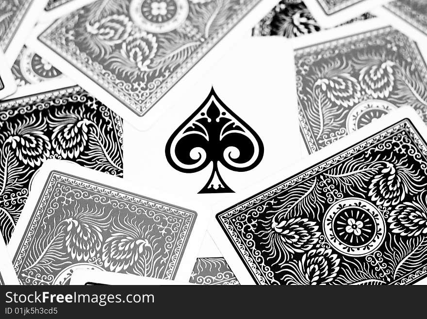 Ace of spades in the centre with other playing cards surrounding it