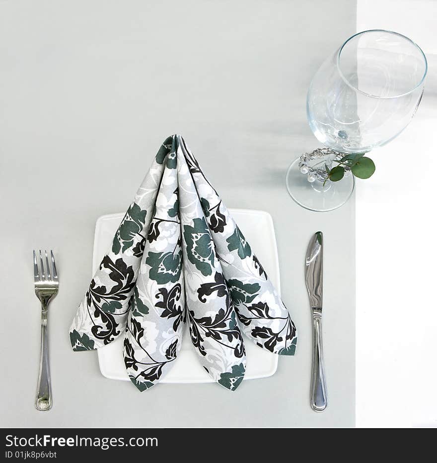 Napkin, glass and silverware on a table. Napkin, glass and silverware on a table