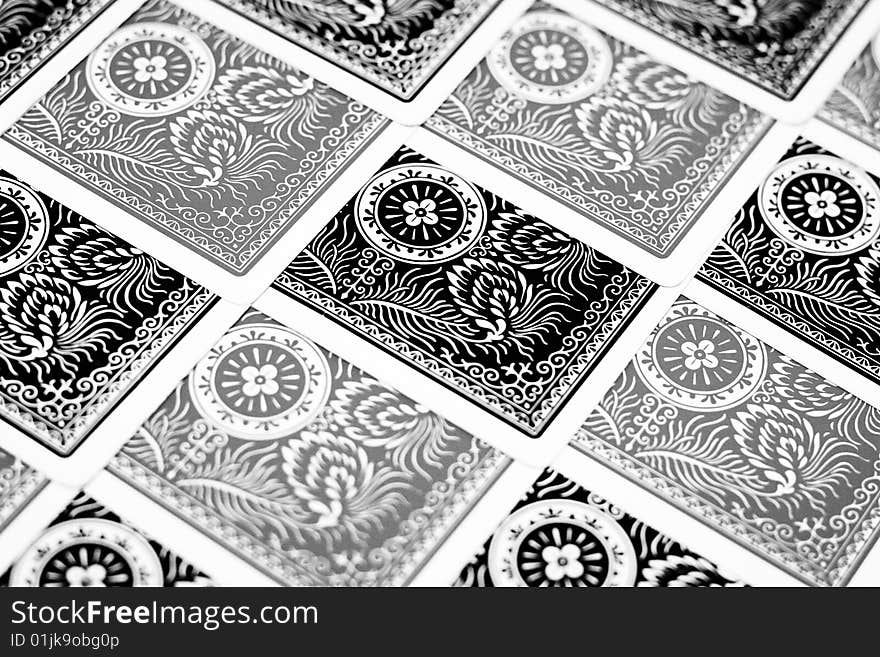 Black and grey playing cards faced down and arranged in a orderly manner. Black and grey playing cards faced down and arranged in a orderly manner.