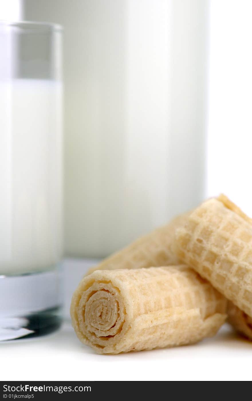 Glass of milk and fresh cookies on a white background. Glass of milk and fresh cookies on a white background