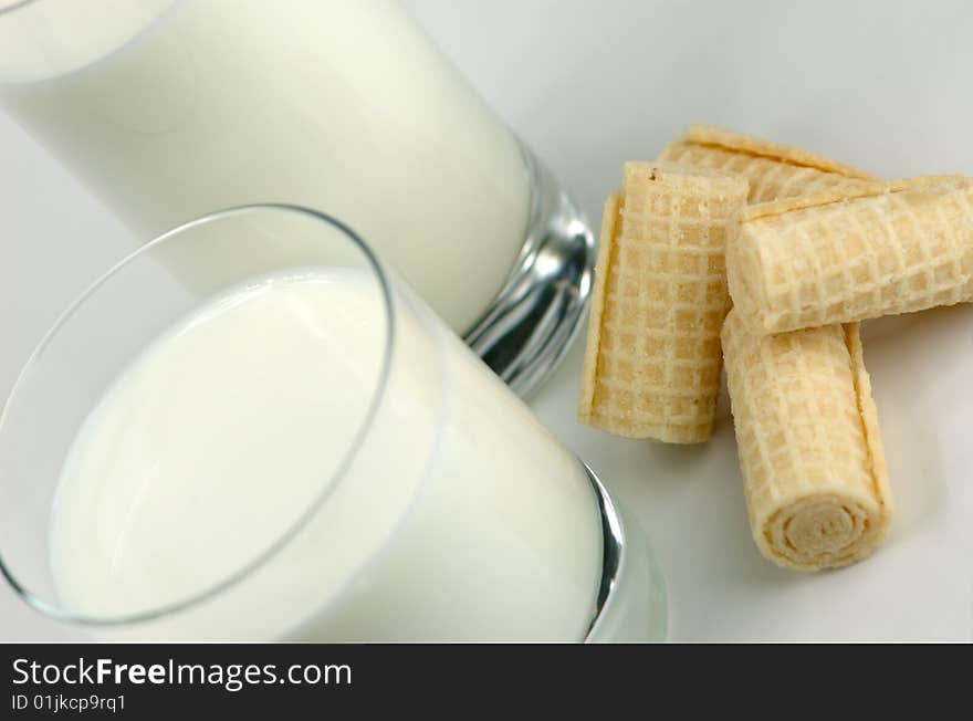 Glass of milk and fresh cookies on a white background. Glass of milk and fresh cookies on a white background