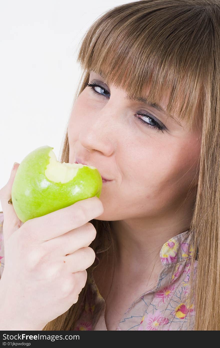 Young blue eyes girl with green apple. Young blue eyes girl with green apple.