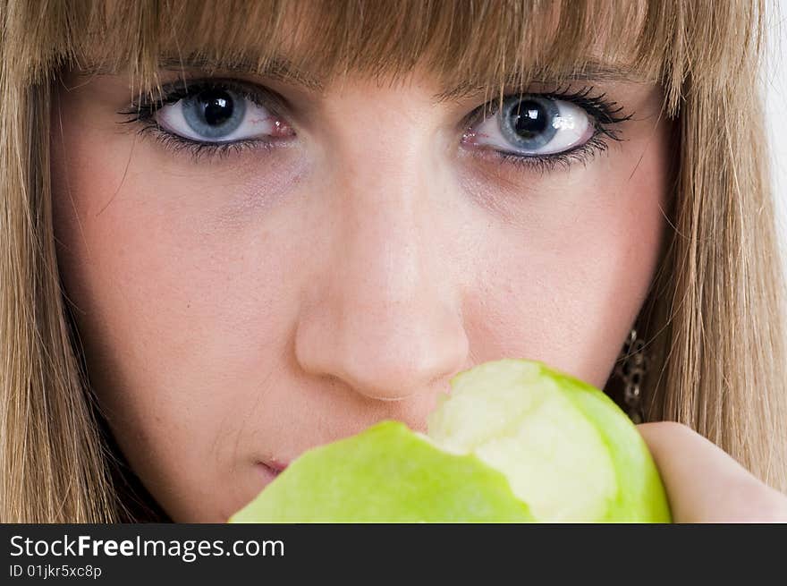 Young blue eyes girl with green apple. Young blue eyes girl with green apple.