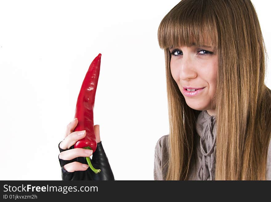 Young blue eyes girl with red paprika in hand.