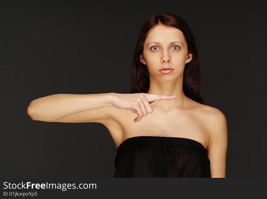 The young lonely woman on a dark background. The young lonely woman on a dark background