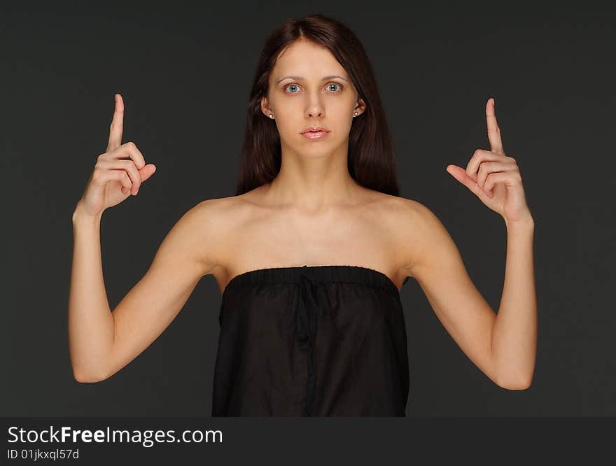 The young lonely woman on a dark background. The young lonely woman on a dark background