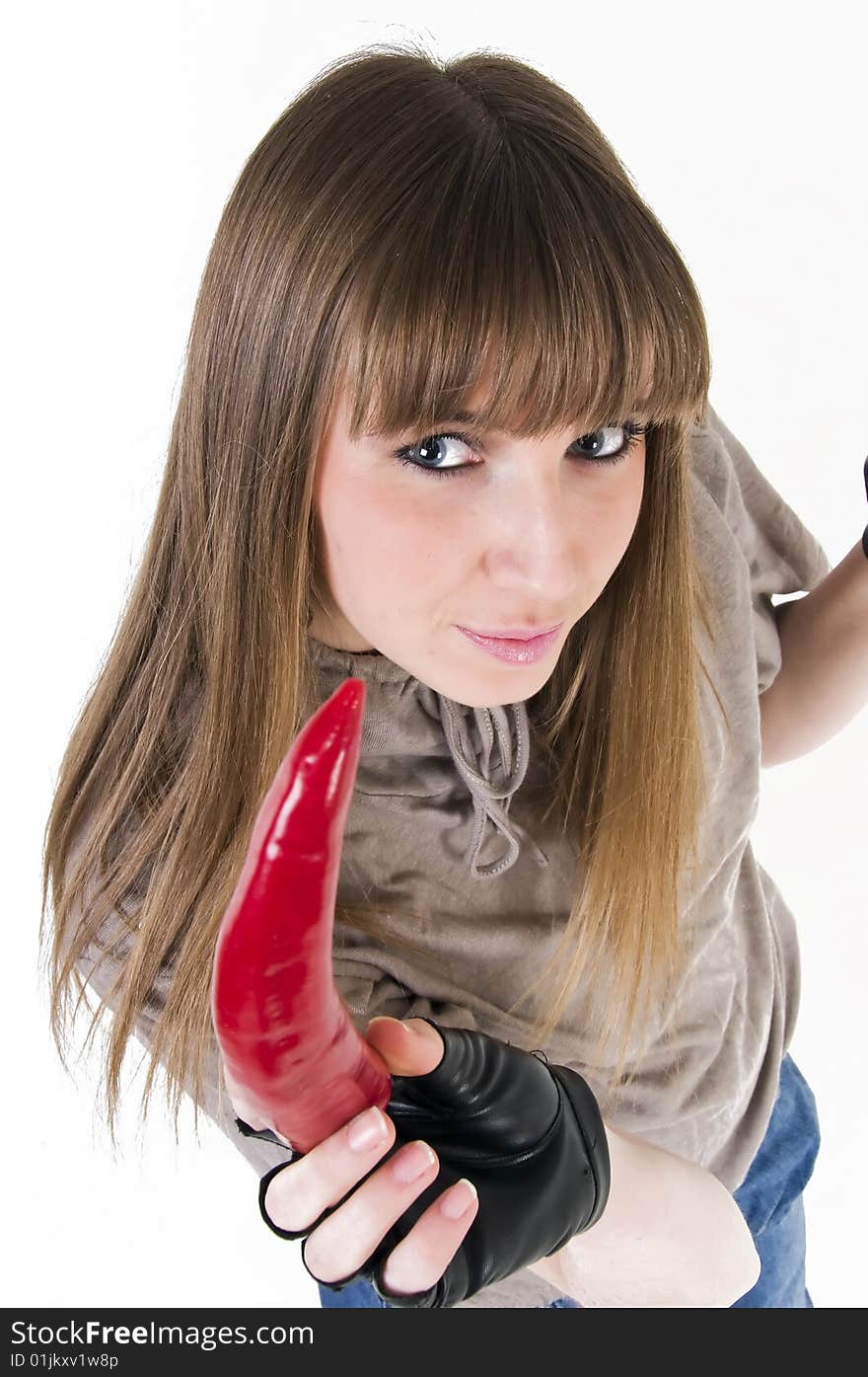 Young blue eyes girl with red paprika in hand.