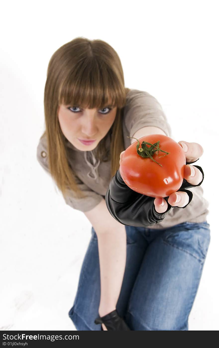 Young girl with fresh red tomato in hand. Young girl with fresh red tomato in hand.