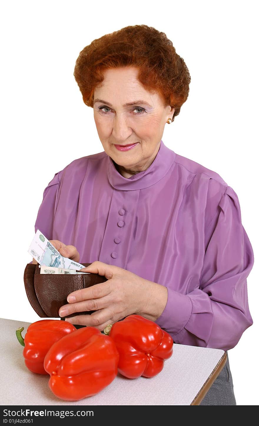 The elderly woman recalculates money separately on a white background. The elderly woman recalculates money separately on a white background