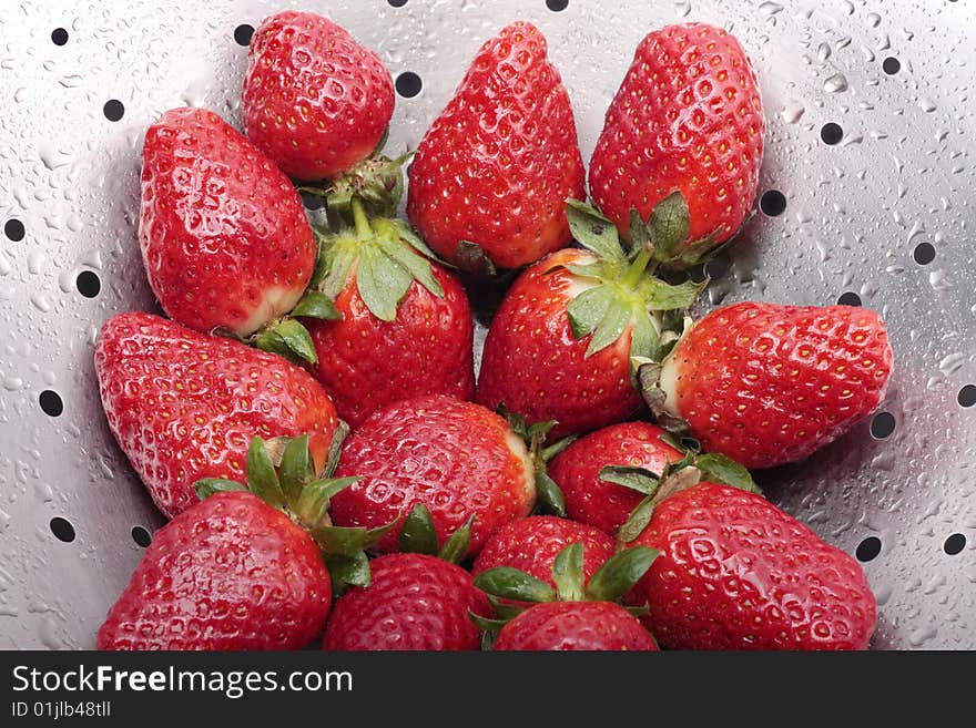 Fresh strawberries in steel colander