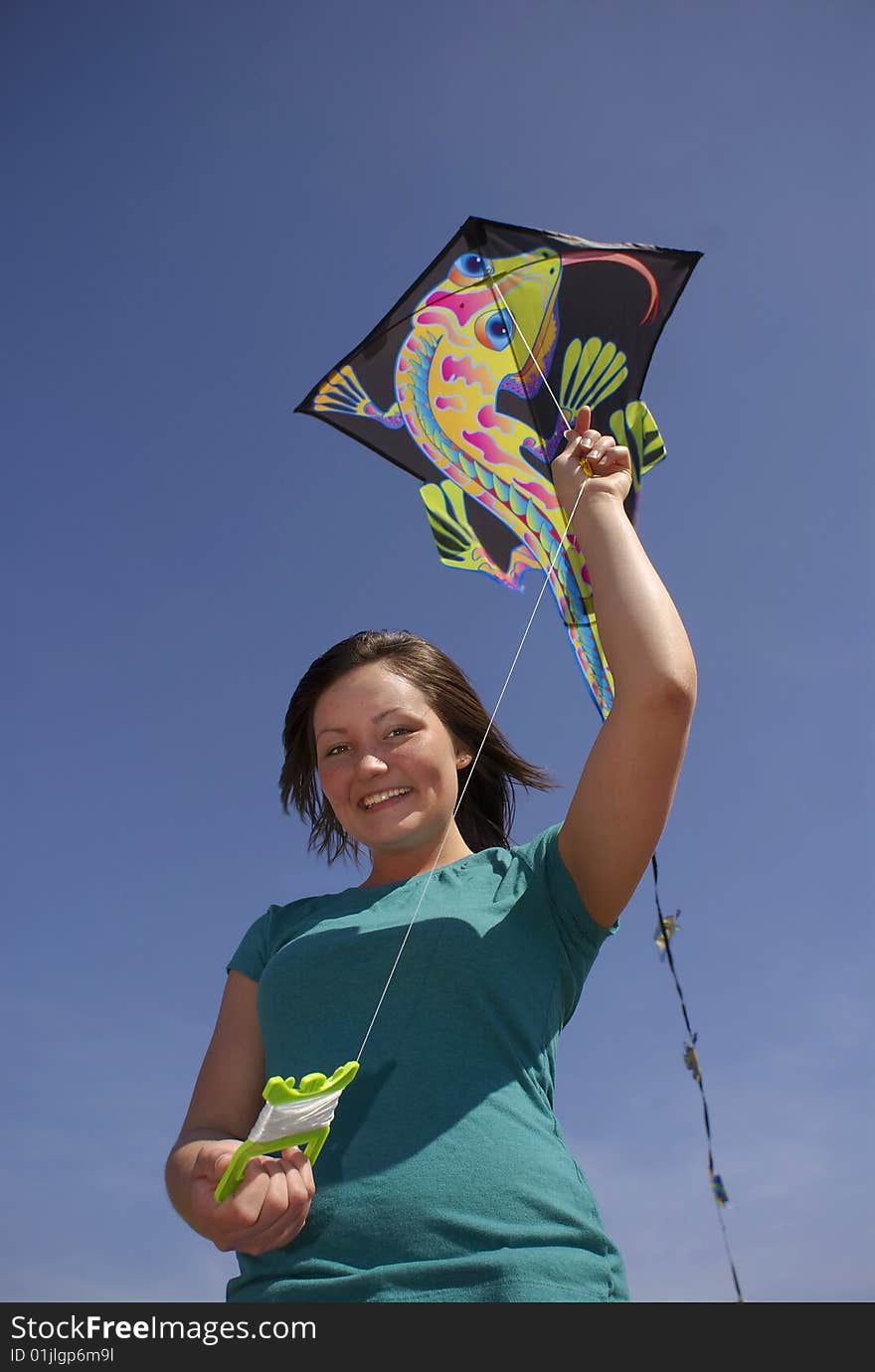 Teen girl holds kite