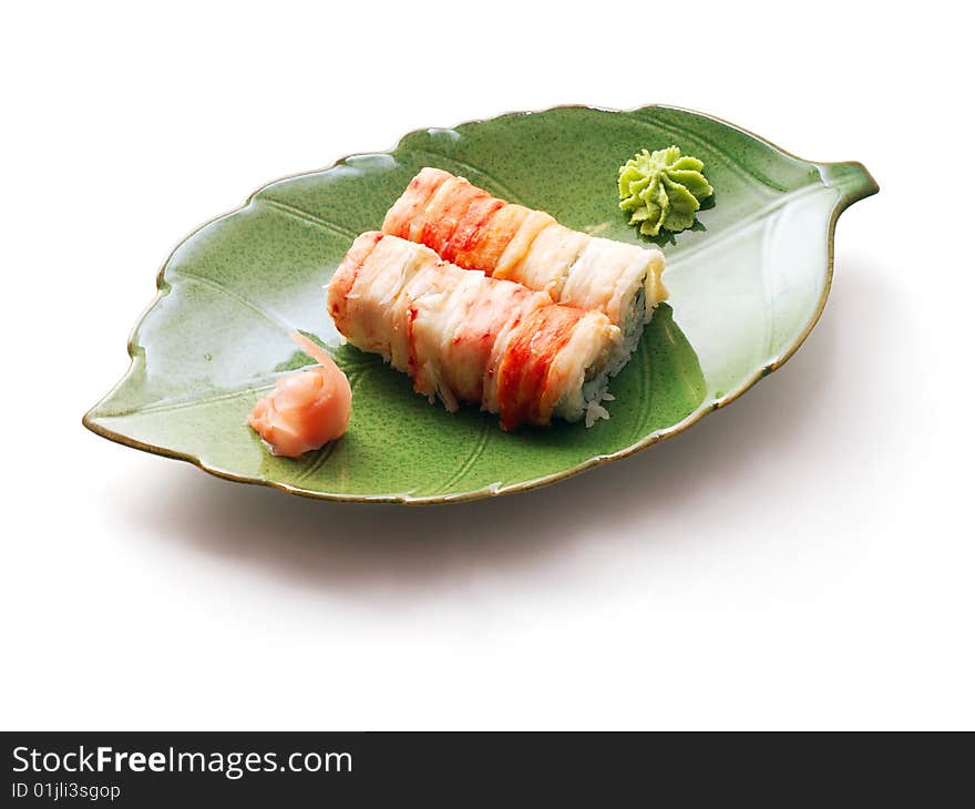 Rolls with crabmeat and tuna in green leaf plate over white background