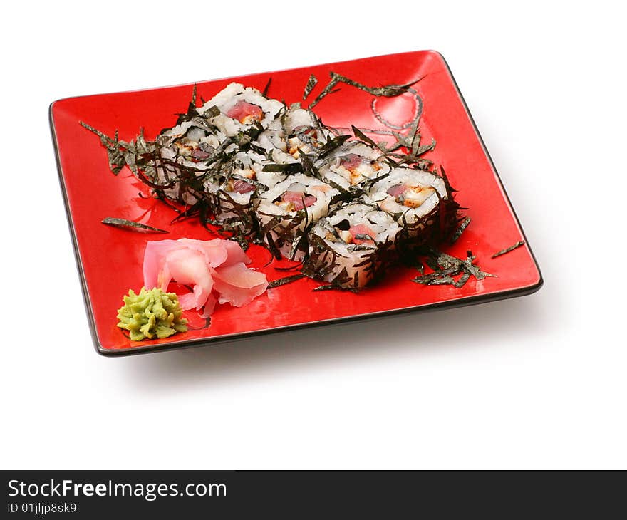 Rolls with seaweed, salmon and octopus in red squared plate over white background