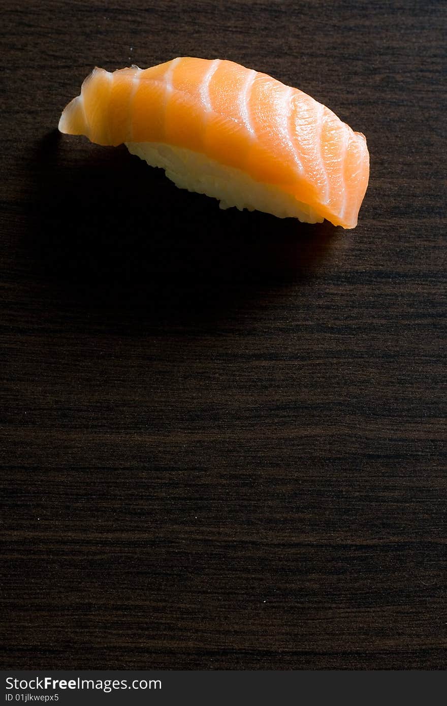 Fish sushi on wooden brown board