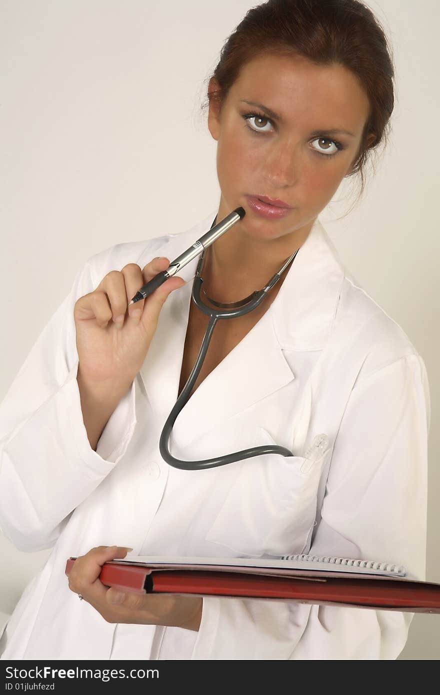 Female doctor with stethoscope on white