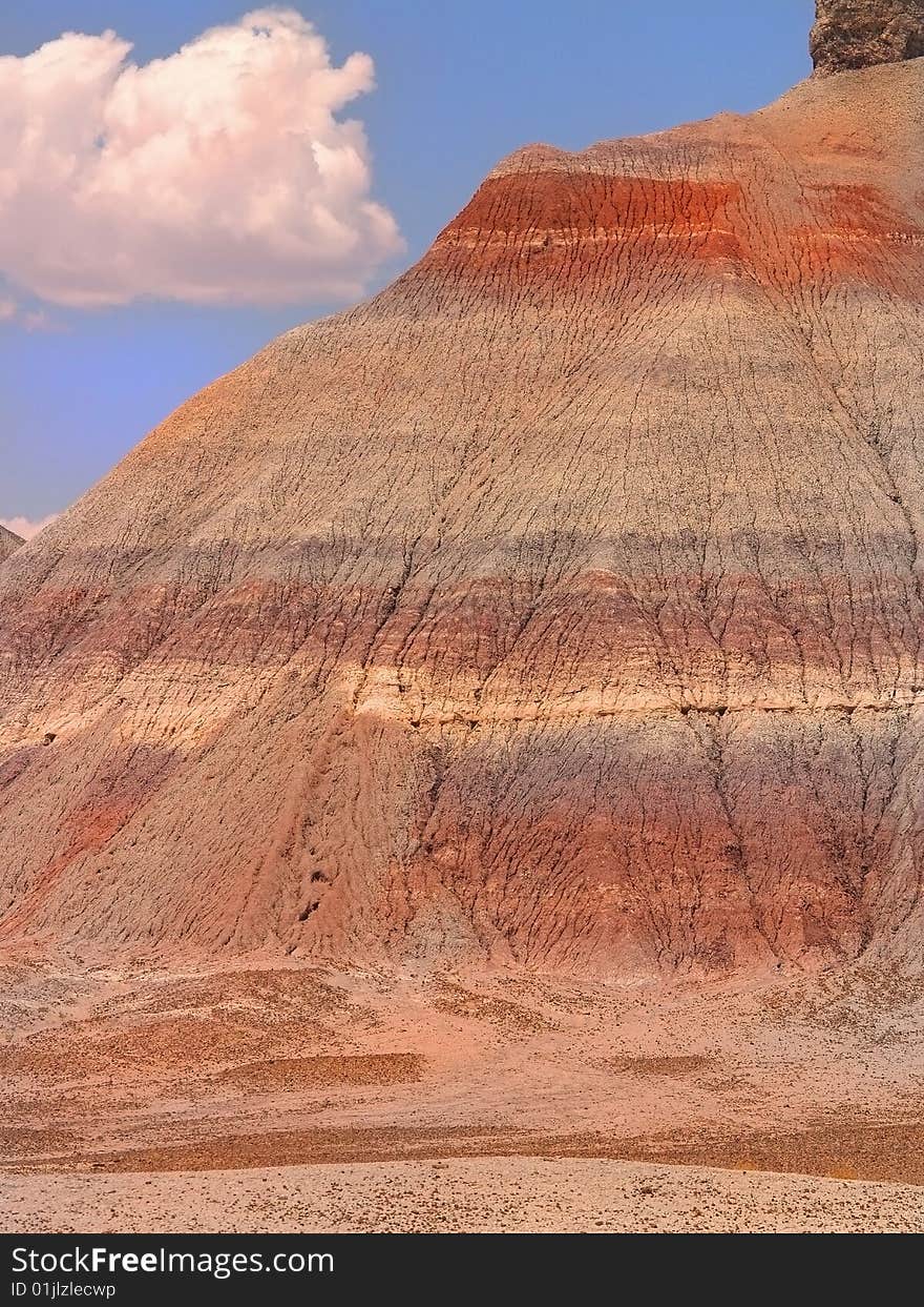 Bands of color appear across a large hill in the Painted Desert, Arizona. Bands of color appear across a large hill in the Painted Desert, Arizona