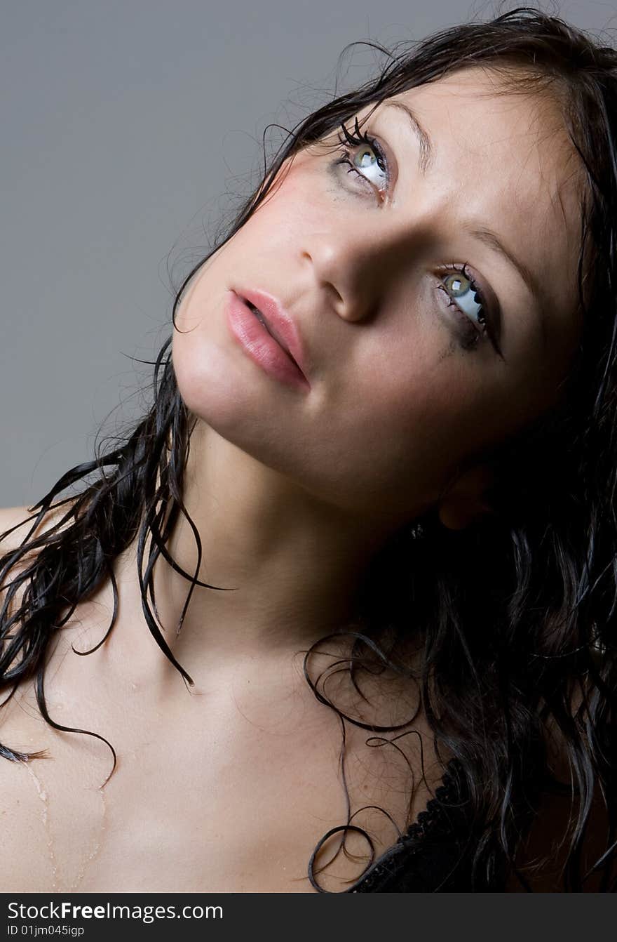 Beautiful wet brunette portrait in studio shot