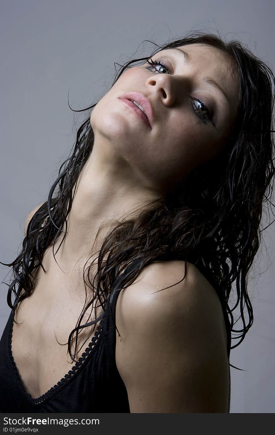 Beautiful wet brunette portrait in studio shot